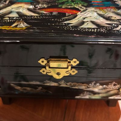 Vintage Asian black lacquer jewelry box featuring mother-of-pearl inlay depicting a landscape with pagodas, mountains, and a bridge,...