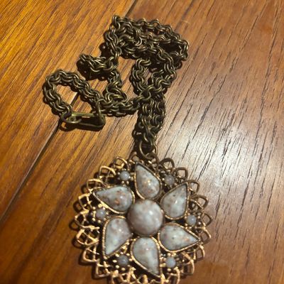Vintage gold-tone filigree pendant necklace featuring a floral design set with speckled white and grey stones on a thick link chain.