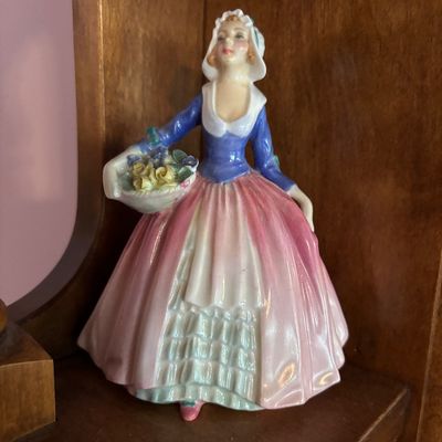 Vintage Royal Doulton porcelain figurine, "The Flower Sellers Children" style, featuring a woman in a blue bodice and pink...