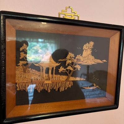 Vintage Chinese cork carving diorama depicting a pagoda landscape, housed in a black and wood-toned frame with a decorative brass hanger.