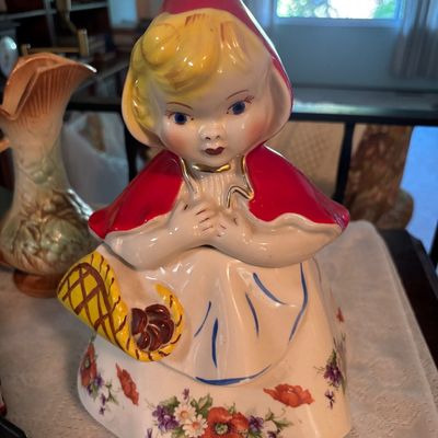 Vintage Hull Pottery Little Red Riding Hood cookie jar, featuring hand-painted floral details and gold accents, circa 1940s.