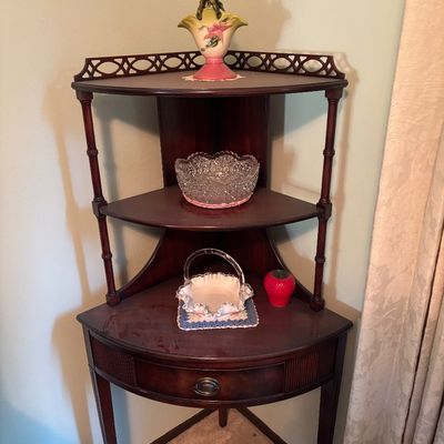 Vintage mahogany corner whatnot shelf featuring three tiers, a single drawer with a brass pull, and decorative fretwork on the top gallery.