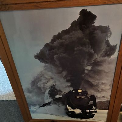Framed photograph of a Japanese Class D51 steam locomotive (D51 158) plowing through snow with a massive plume of dark smoke, housed in a...