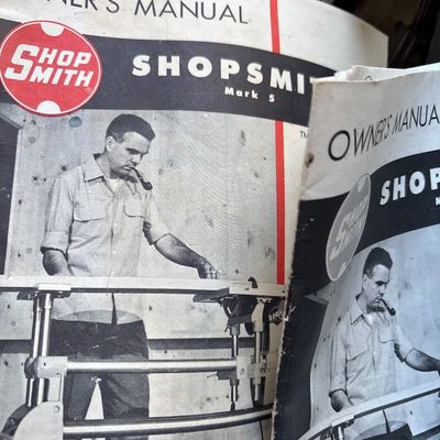 Vintage Shopsmith Mark 5 owner's manuals, showing some wear and creasing on the covers.