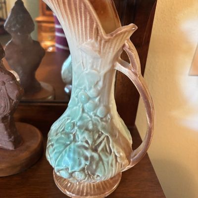 Vintage Hull art pottery ewer in the Water Lily pattern, featuring a soft green and brown matte glaze with embossed floral details.