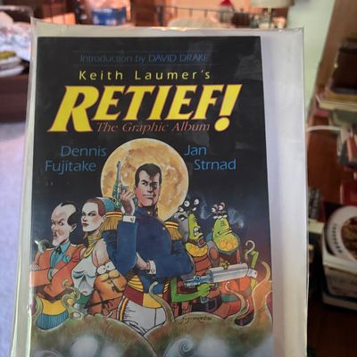 "Keith Laumer's Retief! The Graphic Album" comic book, published in 1990, preserved in a protective plastic sleeve.