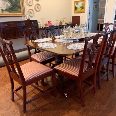 Sale Photo Thumbnail #17: Chippendale-style mahogany dining set featuring a double-pedestal extension table and eight matching chairs with striped upholstered seats.