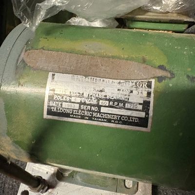 Vintage Ta Loong Electric Machinery Co. induction motor, dated 1983, featuring a green housing and original specification plate.