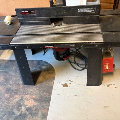 Craftsman Deluxe Router Table, model 925481, featuring a black metal frame and integrated power switch.