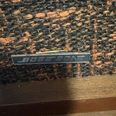 Vintage Bose 901 Series II speaker badge on a textured brown and black woven grille cloth.