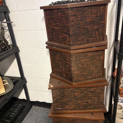 Stack of four vintage mid-century modern speakers featuring wooden cabinets and textured brown and orange grille cloth.
