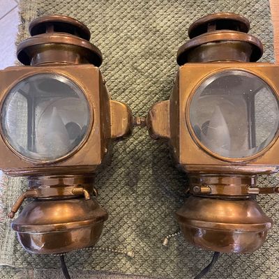 Sale Photo Thumbnail #98: Pair of vintage brass carriage-style wall sconce lanterns with circular glass windows and pull-chain switches.