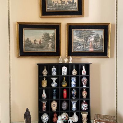 Sale Photo Thumbnail #93: Black shadow box shelf filled with miniature Asian porcelain vases, accompanied by decorative figurines.