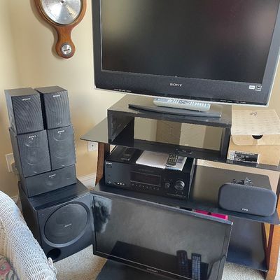 Sale Photo Thumbnail #18: Sony Bravia flat-screen television, audio/video receiver, subwoofer, and surround sound speakers, black glass media stand,  smaller Samsung TV.