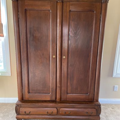 Sale Photo Thumbnail #12: Antique knockdown wardrobe featuring carved shell corners, column accents, two panel doors, and a bottom section with two drawers.