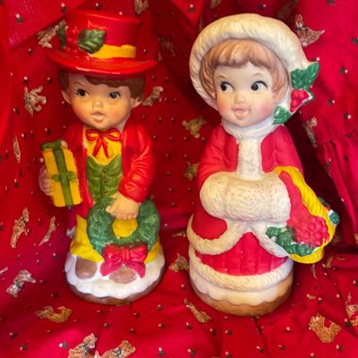 Sale Photo Thumbnail #135: Pair of vintage hand-painted ceramic Christmas caroler figurines depicting a boy with a wreath and a girl in a fur-trimmed coat.