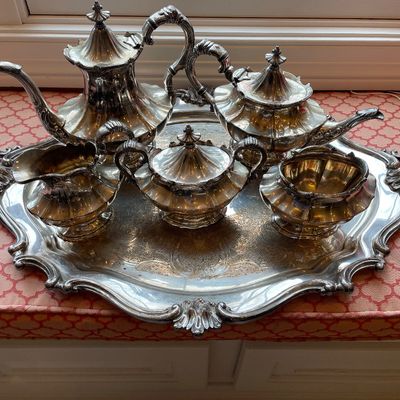 Sale Photo Thumbnail #164: Ornate silver-plated tea and coffee service, including a teapot, coffee pot, creamer, lidded sugar bowl, waste bowl, and matching engraved serving tray.