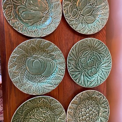 Sale Photo Thumbnail #117: Set of six vintage green majolica ceramic dessert plates, featuring molded relief fruit and leaf motifs.