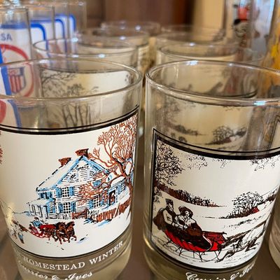 Sale Photo Thumbnail #108: Vintage Currier & Ives frosted glass tumblers featuring colorful winter scenes, set among a larger collection of glass drinkware.