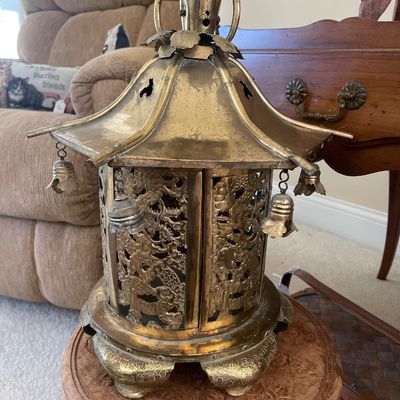 Sale Photo Thumbnail #50: Vintage Asian brass pagoda-style candle lantern featuring ornate pierced dragon panels, hanging miniature bells, and a top carrying handle.