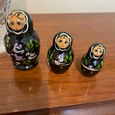 Sale Photo Thumbnail #46: hand-painted Russian matryoshka nesting dolls featuring a black glossy background with purple floral motifs.