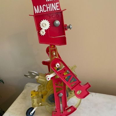 Sale Photo Thumbnail #94: Vintage Ideal Toy Company Mr. Machine mechanical robot toy, featuring a red top hat, clear plastic body, and winding key mechanism, circa 1960s.