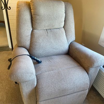 Sale Photo Thumbnail #8: Power lift recliner upholstered in a beige woven fabric, complete with attached wired remote control.