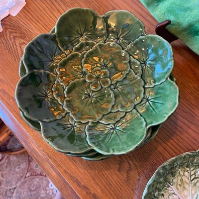 Sale Photo Thumbnail #119: Stack of vintage Portuguese majolica green ceramic plates featuring a scalloped water lily leaf pattern with a glossy glaze.