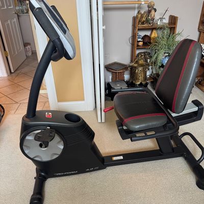 Sale Photo Thumbnail #33: Pro-Form 4.0 ES recumbent exercise bike featuring a black frame, padded seat with red trim, and digital display console.