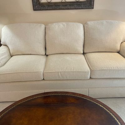Sale Photo Thumbnail #4: Smith Brothers three-cushion sofa upholstered in a light beige or cream textured fabric, featuring a tailored kick-pleat skirt. Like new condition.