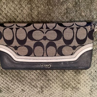 Sale Photo Thumbnail #191: Coach signature pattern zip-around checkbook wallet featuring black jacquard canvas, dark navy trim, and silver-tone script hardware.