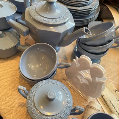 Sale Photo Thumbnail #88: Vintage light blue plastic child's tea set featuring an embossed floral trim pattern on the teapot, sugar bowl, and plates.