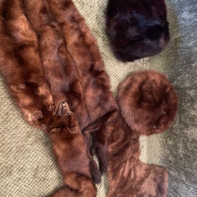Sale Photo Thumbnail #192: Vintage mink fur stole featuring full-body pelts with head and feet details, accompanied by tw fur hats.