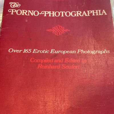 Sale Photo Thumbnail #70: Vintage paperback book titled 'The Porno-Photographia,' compiled and edited by Reinhard Seufert, featuring moderate wear along the spine and cover edges.