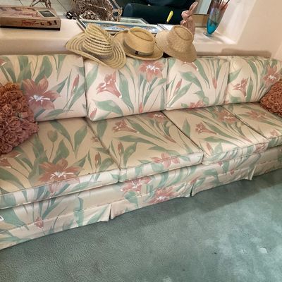 Sale Photo Thumbnail #50: Vintage four-cushion sofa featuring a pastel floral pattern in shades of pink and green, accompanied by two textured rose-accented throw pillows.