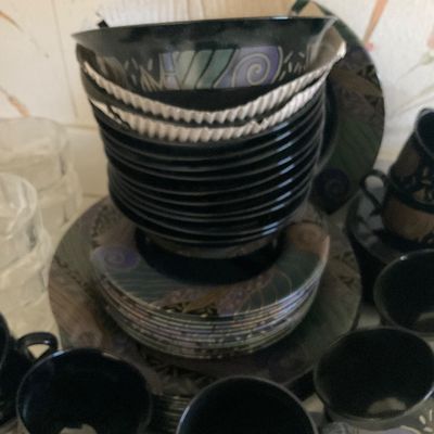 Sale Photo Thumbnail #38: Vintage 1990s black ceramic dinnerware set featuring abstract pastel and metallic patterns, including plates, bowls, and matching mugs.
