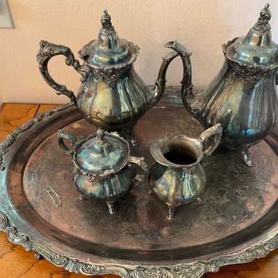 Sale Photo Thumbnail #6: Vintage silver-plated tea and coffee service set, including a teapot, coffee pot, creamer, and lidded sugar bowl, displayed on a matching ornate serving tray with heavy tarnish.