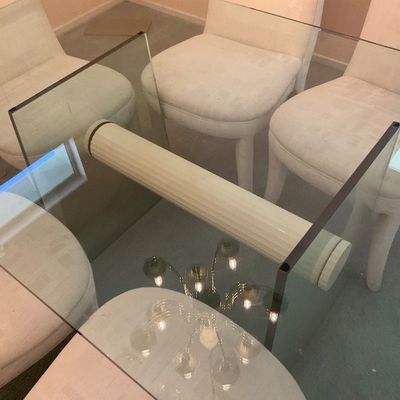 Sale Photo Thumbnail #2: Postmodern glass dining table featuring a thick glass top supported by a sculptural glass base with a central fluted column, paired with upholstered dining chairs.