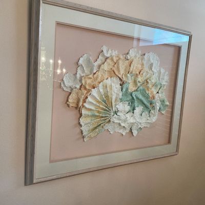 Sale Photo Thumbnail #4: Framed 3D handmade paper art piece featuring textured, fan-like shapes in pastel tones, mounted on a pink mat in a light wood frame.
