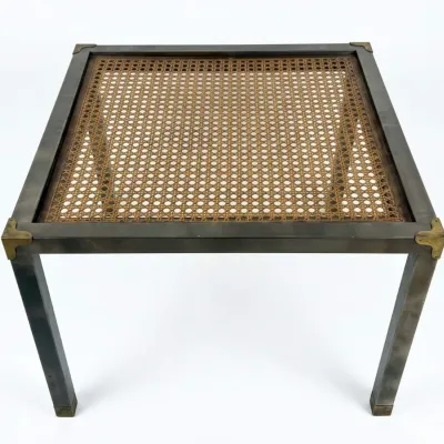 Sale Photo Thumbnail #6: Mid-century modern campaign-style side table featuring a dark metal frame with brass corner brackets and a woven cane top under glass.
