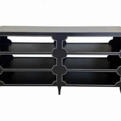 Sale Photo Thumbnail #57: Hollywood Regency style black lacquered console table featuring six open shelves with decorative quatrefoil-inspired cutouts outlined in silver trim.