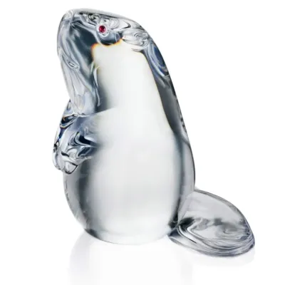 Sale Photo Thumbnail #70: Steuben crystal beaver figurine featuring a polished clear body and a small red gemstone eye.