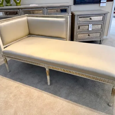 Sale Photo Thumbnail #60: Neoclassical style chaise lounge featuring cream-colored satin upholstery, a painted white frame with gold-leaf accents, and fluted legs.