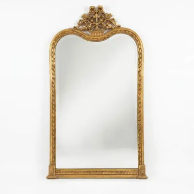Sale Photo Thumbnail #52: French Louis Philippe style giltwood mirror, featuring an arched top adorned with an ornate floral and ribbon crest.
