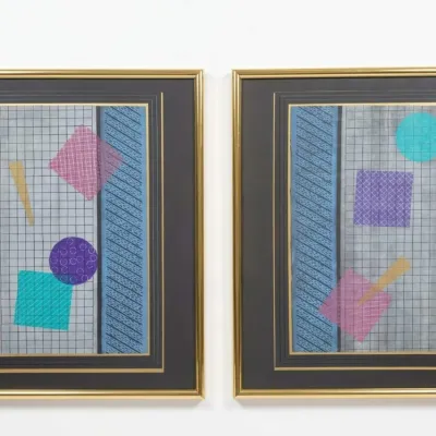 Sale Photo Thumbnail #30: Pair of framed 1980s Memphis-style geometric mixed media artworks, featuring colorful shapes on a grid background with gold-toned frames and dark matting.