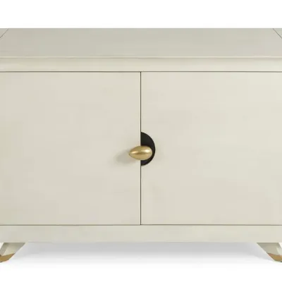 Sale Photo Thumbnail #79: Contemporary off-white lacquered credenza featuring two doors with a central gold-toned oval pull and gold-tipped splayed legs.