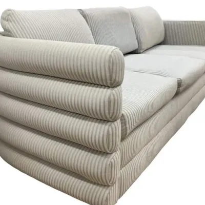 Sale Photo Thumbnail #77: Postmodern three-seater sofa featuring a channel-tufted, tiered rolled design in a light grey and white striped fabric.