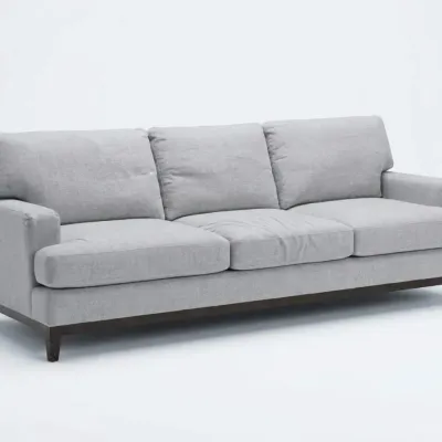 Sale Photo Thumbnail #81: Contemporary three-seat sofa upholstered in light gray fabric, featuring a dark wood base and tapered legs.