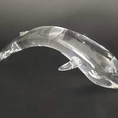 Sale Photo Thumbnail #67: Vintage Baccarat clear crystal dolphin figurine, featuring a sleek, arched design in excellent condition.
