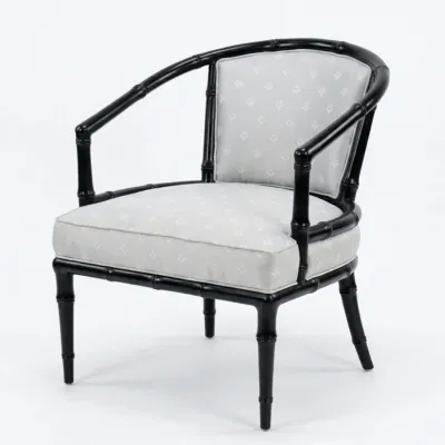 Sale Photo Thumbnail #36: Hollywood Regency style barrel-back armchair featuring a black faux-bamboo frame and light grey patterned upholstery.